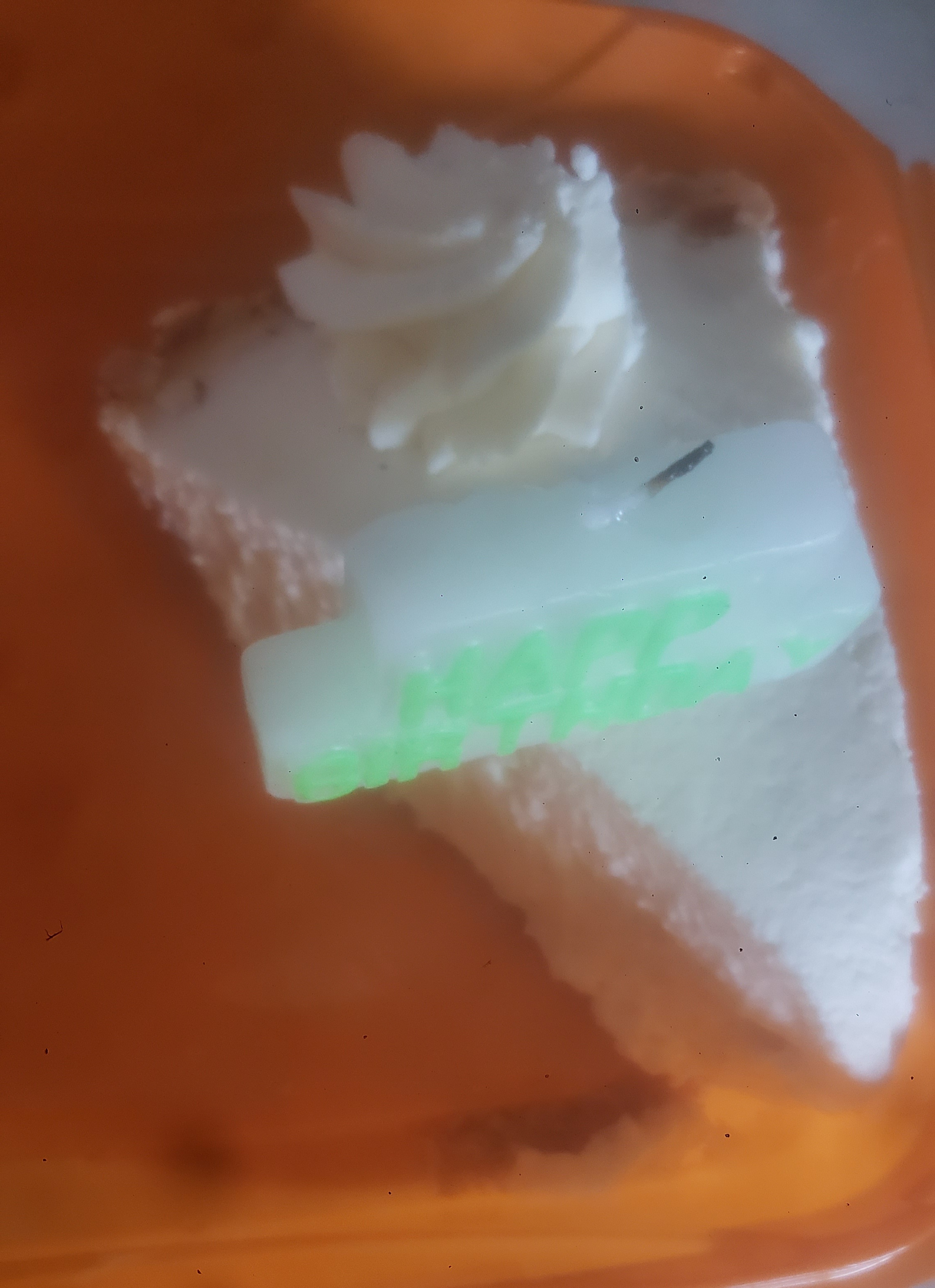 Slice of keylime candle with birthday candle.